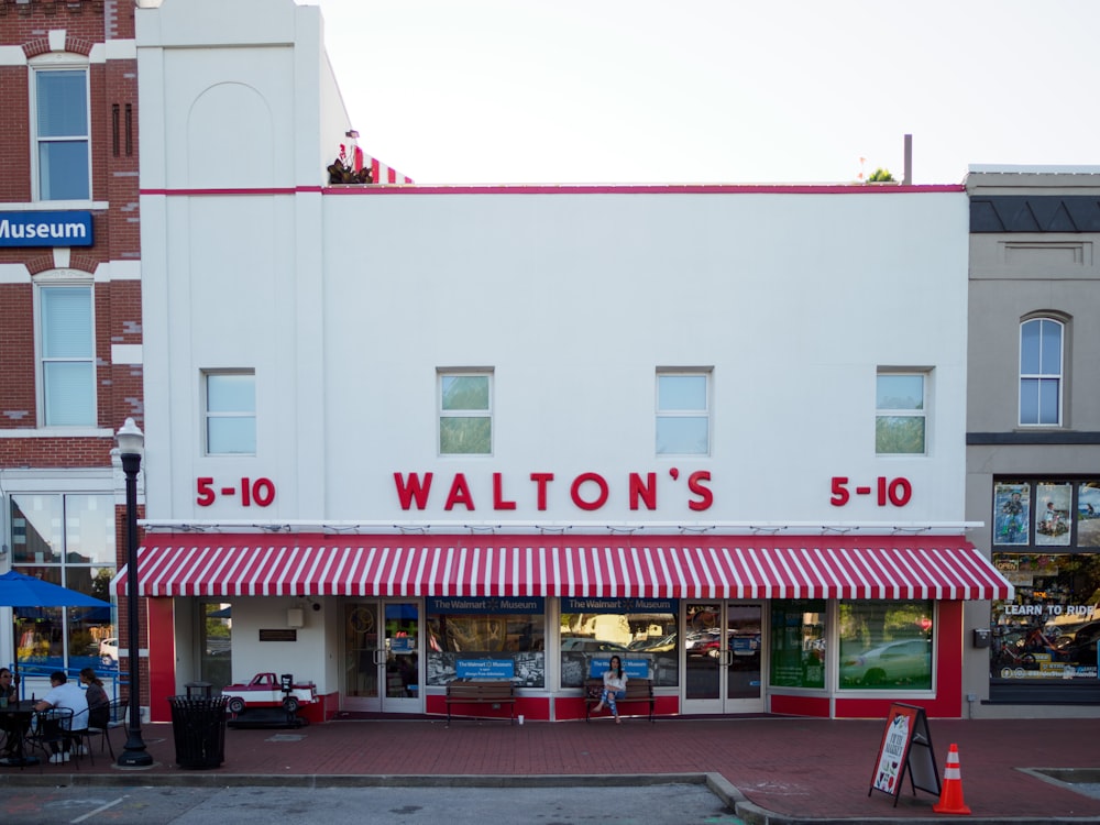 a store front with a red and white awning