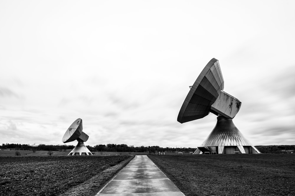 a black and white photo of two satellite dishes