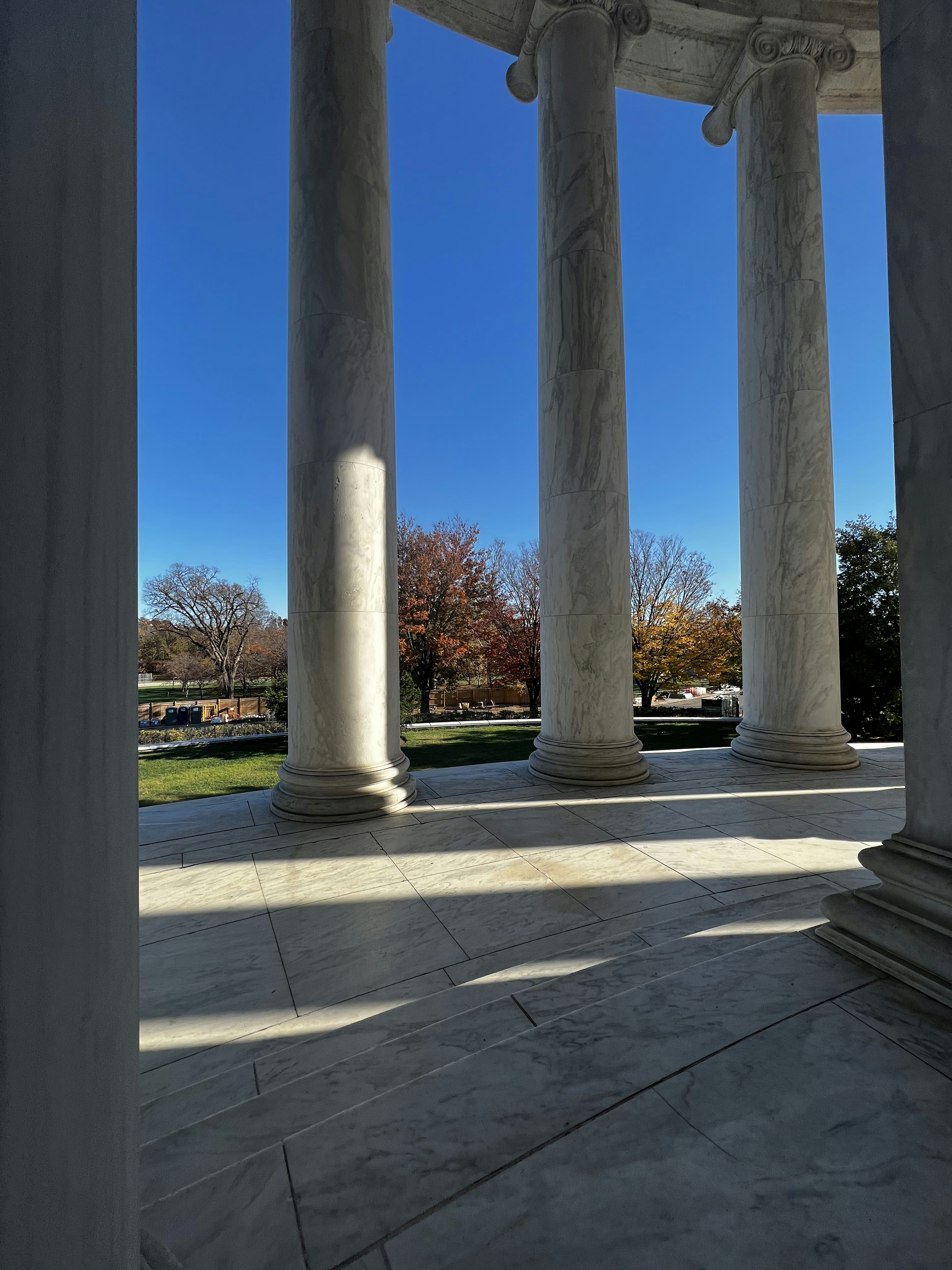 the columns of a building with a blue sky in the background