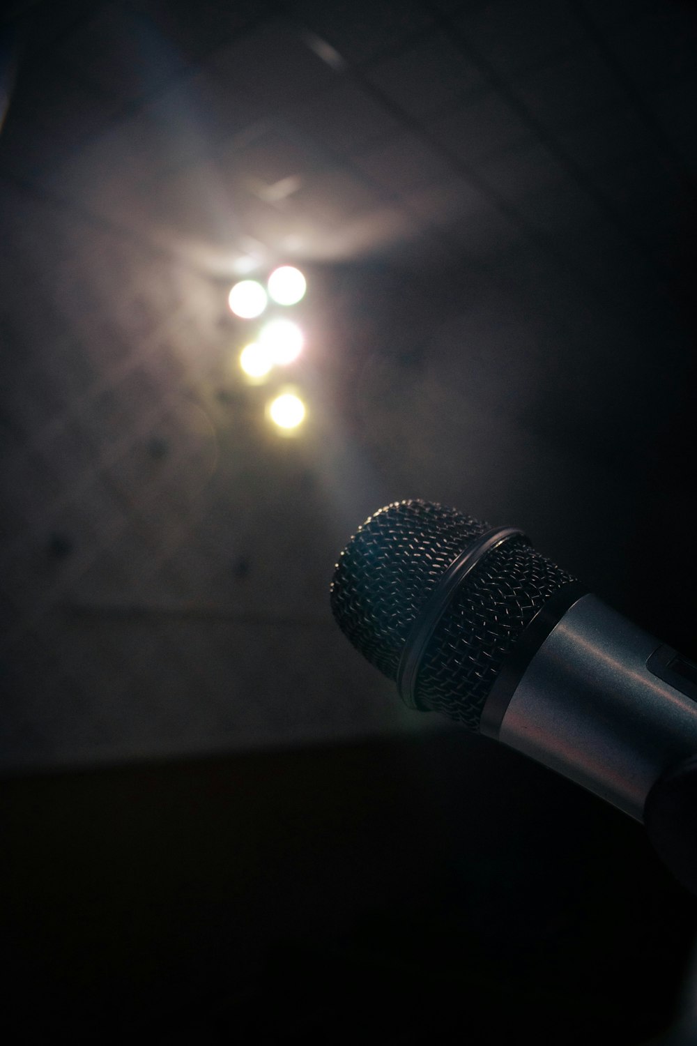 a microphone with a light shining in the background