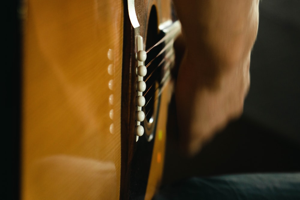 a close up of a person playing a guitar