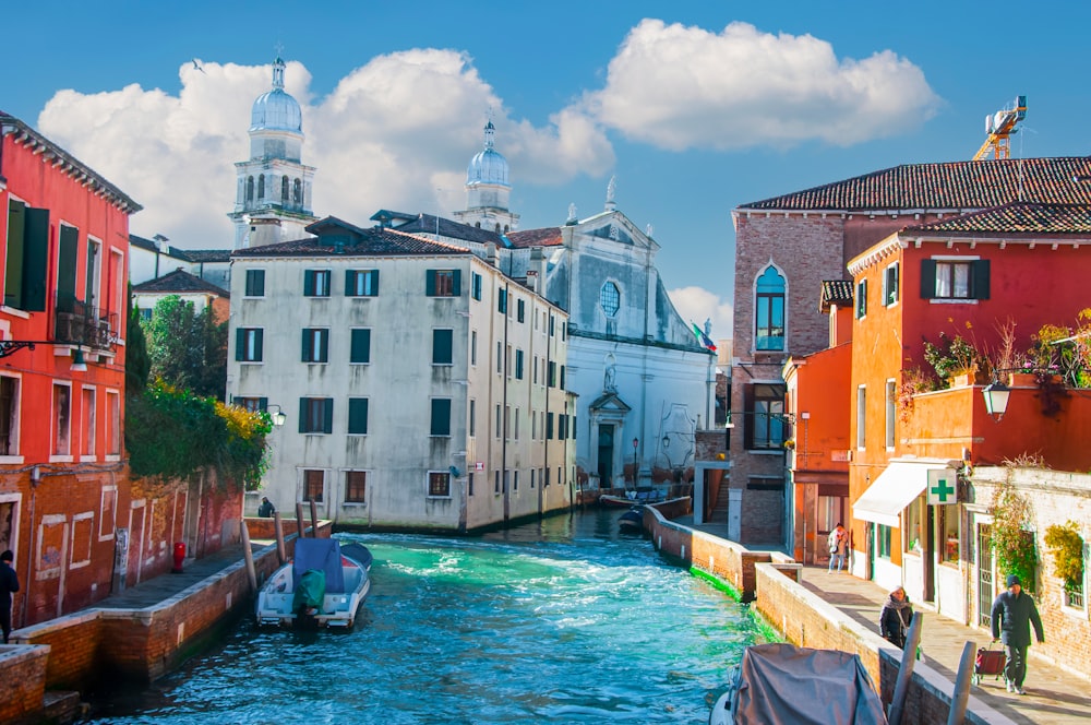 a river running through a city next to tall buildings