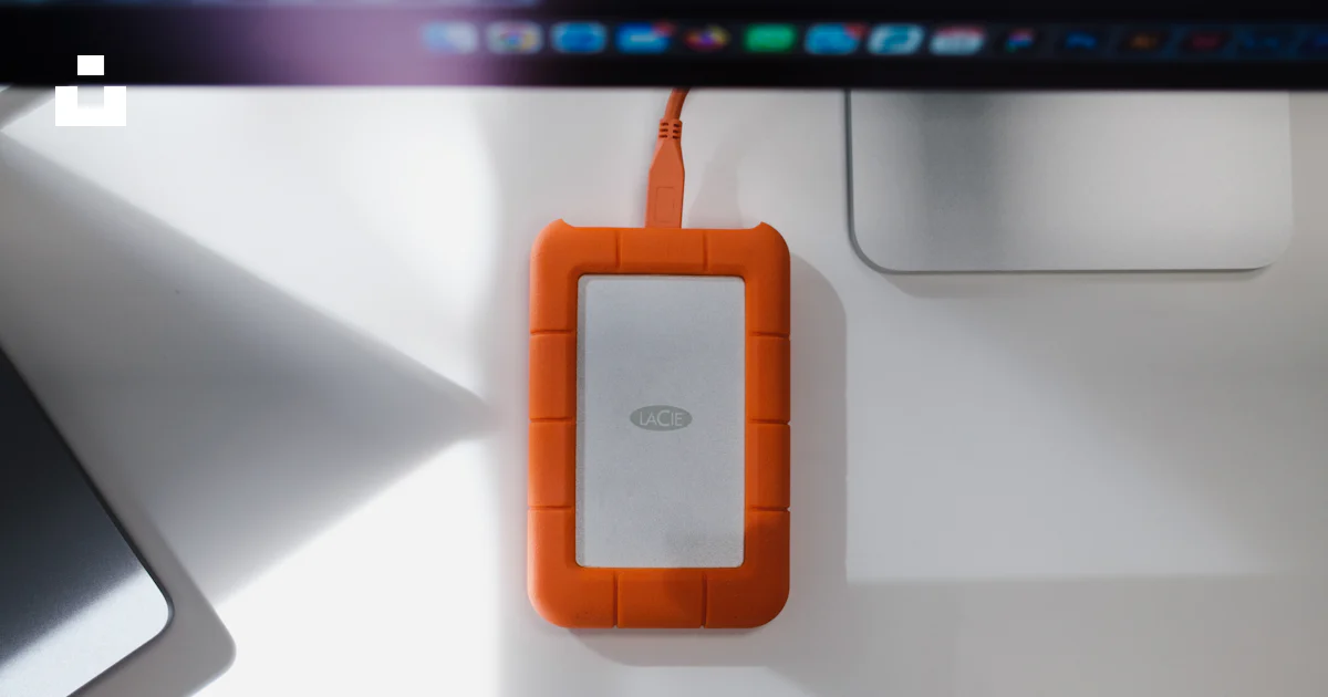 An orange device plugged into a laptop computer photo – Free Technology ...