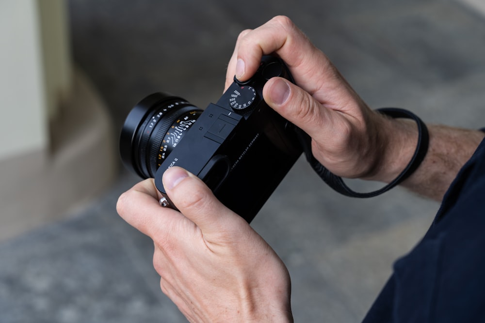 a man holding a camera up to take a picture