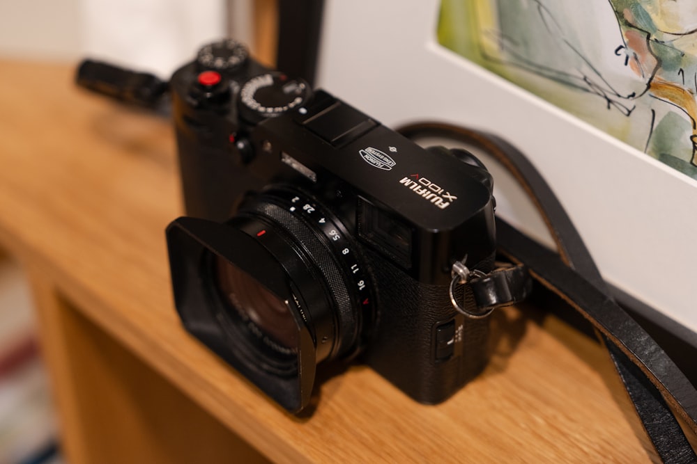 a camera sitting on top of a wooden table