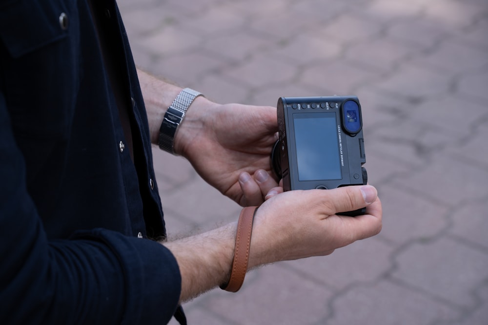 a man holding a cell phone in his hand