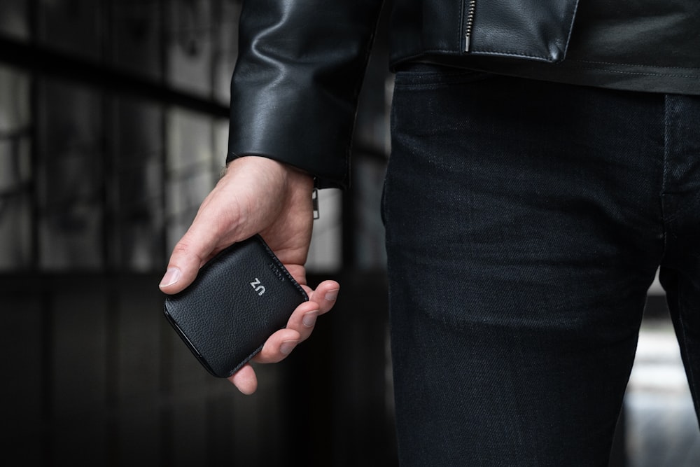 a person holding a cell phone in their hand