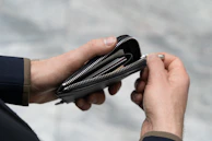 A stylish wallet open to reveal the Stargate Holding membership card alongside other essentials.