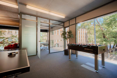 A sleek, modern football agency office with black, white, and gold accents reflecting a premium brand.