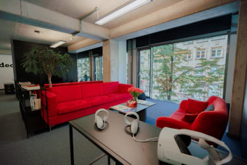 A serene office space with a VR headset resting on a desk, sunlight streaming through a window.