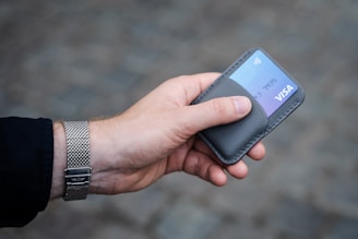 a person holding a credit card in their hand