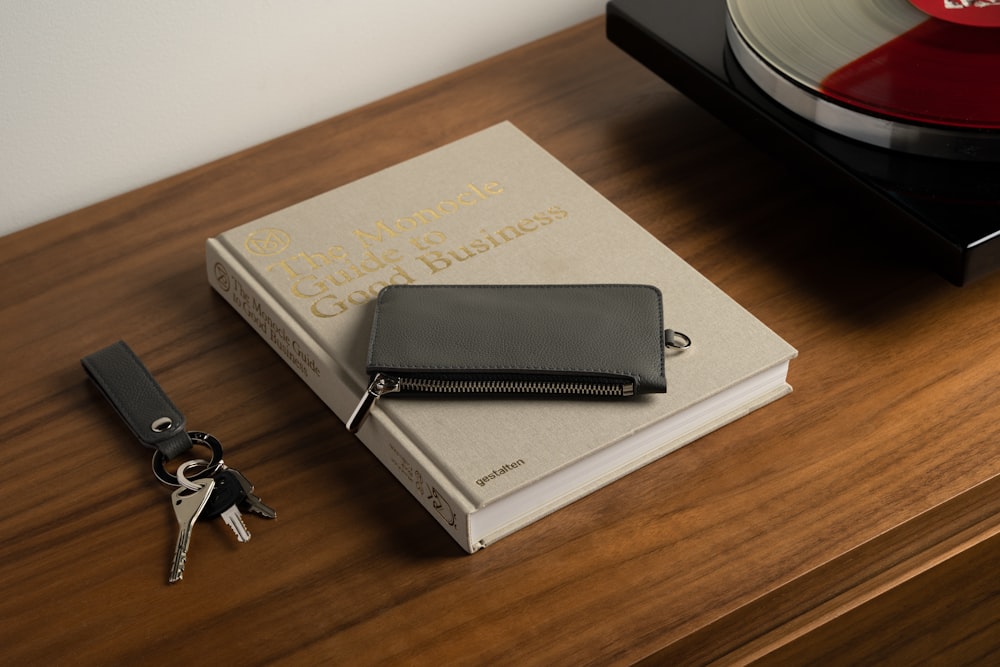 a record player and a wallet on a table