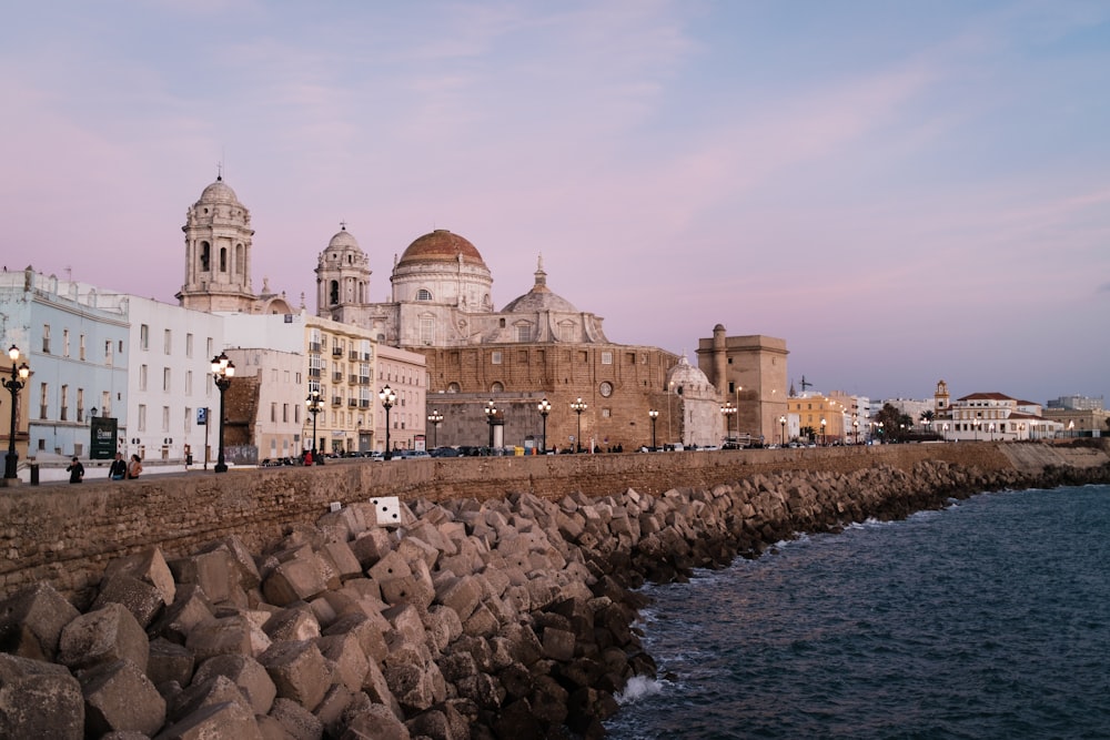 a large body of water next to a row of buildings