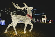 A group of colorful LED-lit reindeer figures arranged in a festive outdoor setting.