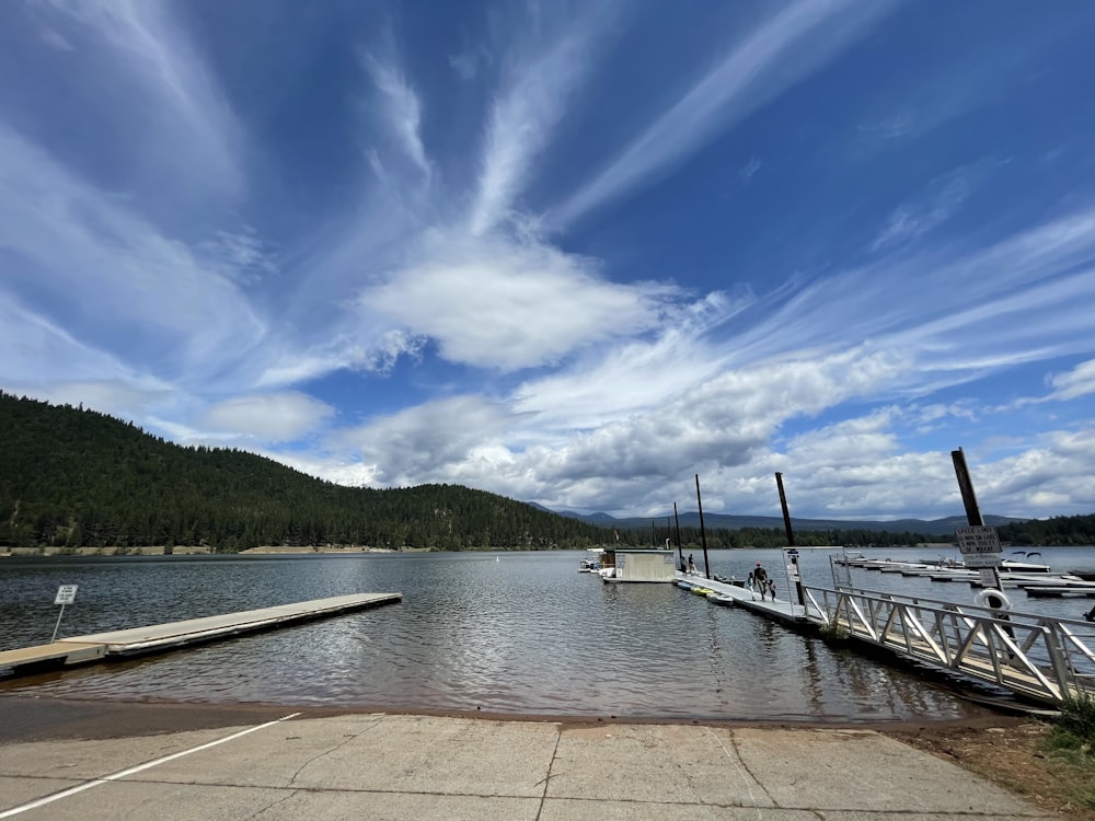 a dock on a lake with a few boats in it