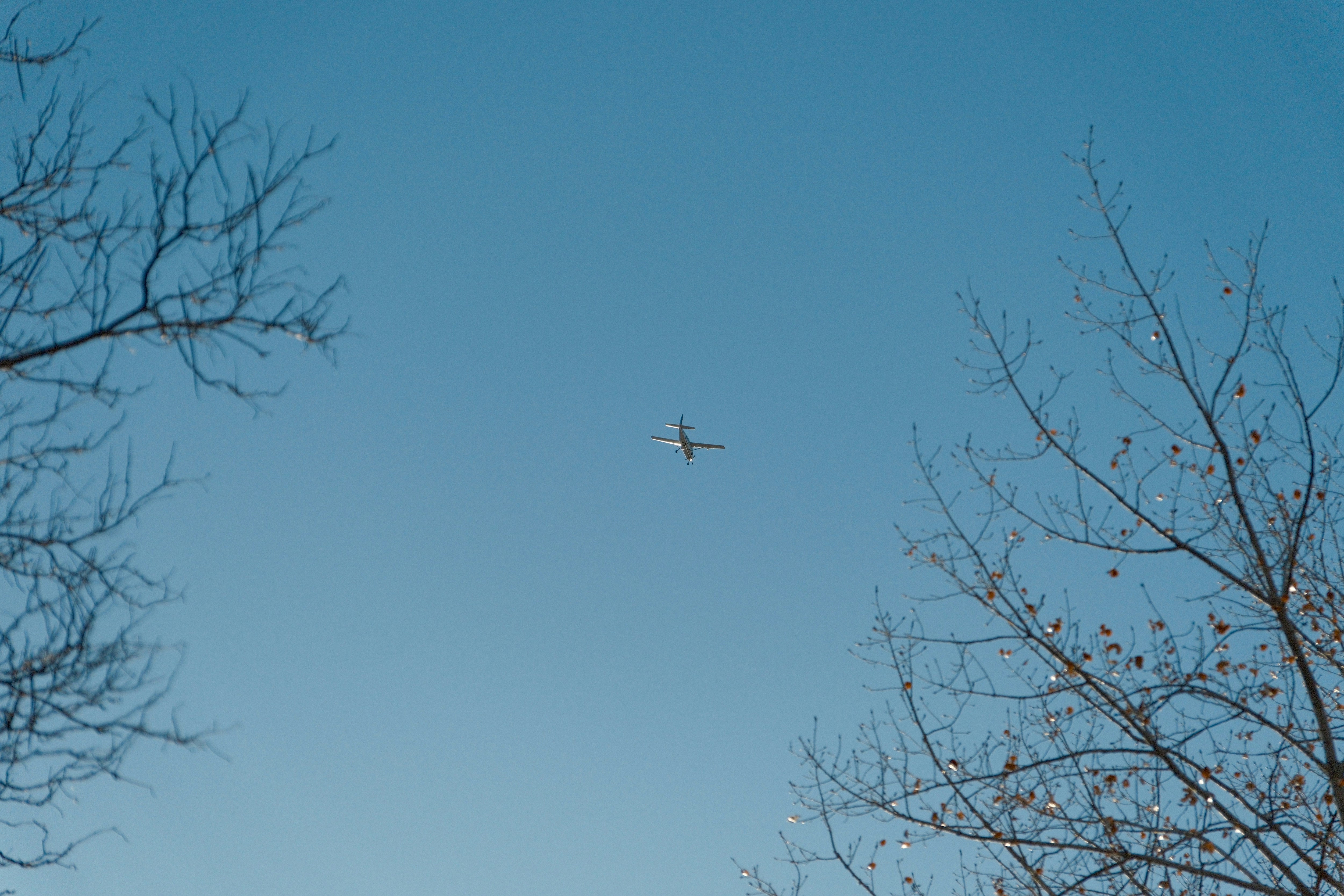 an airplane is flying high in the sky, 