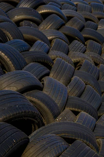 a large pile of old tires stacked on top of each other