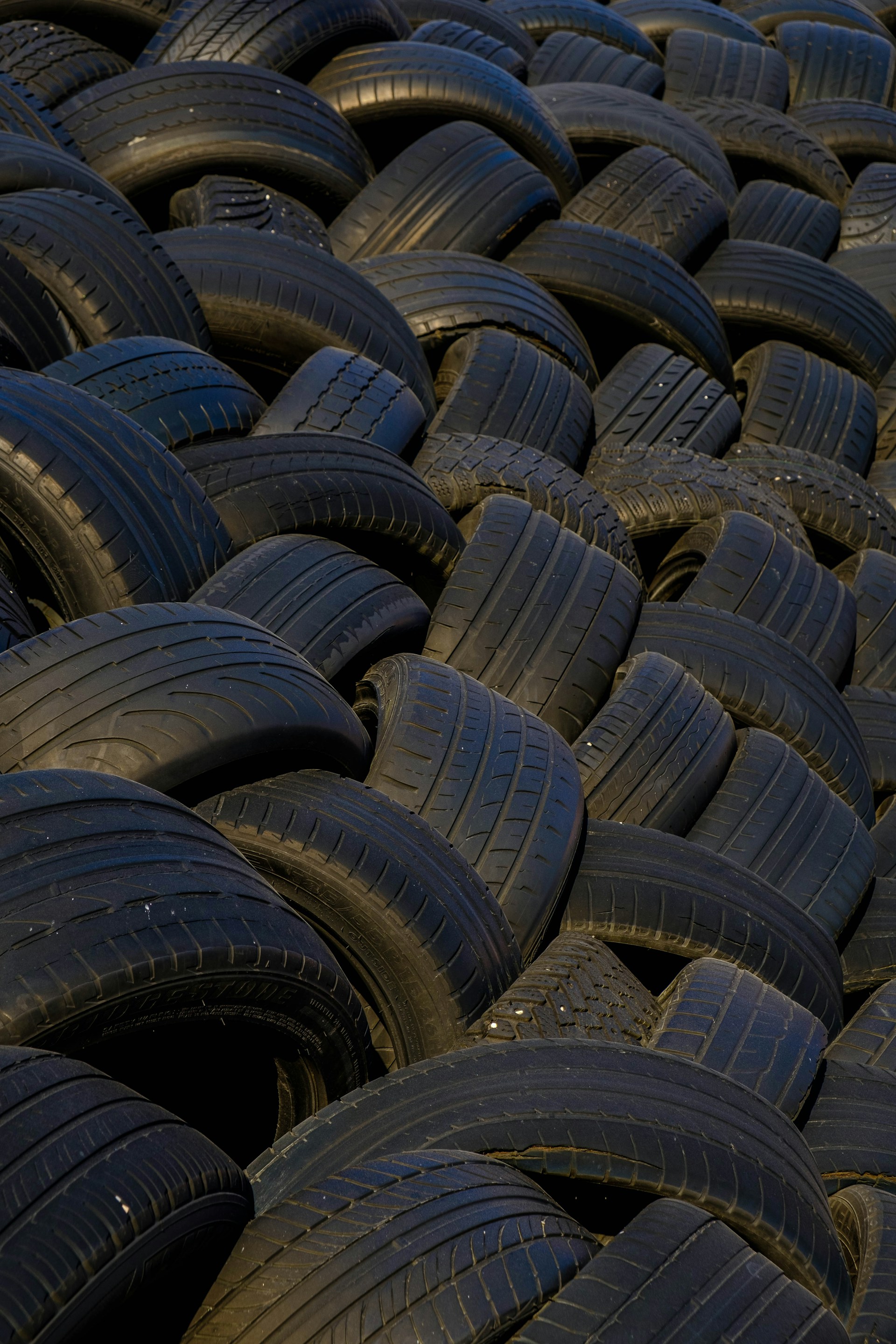 a large pile of old tires stacked on top of each other