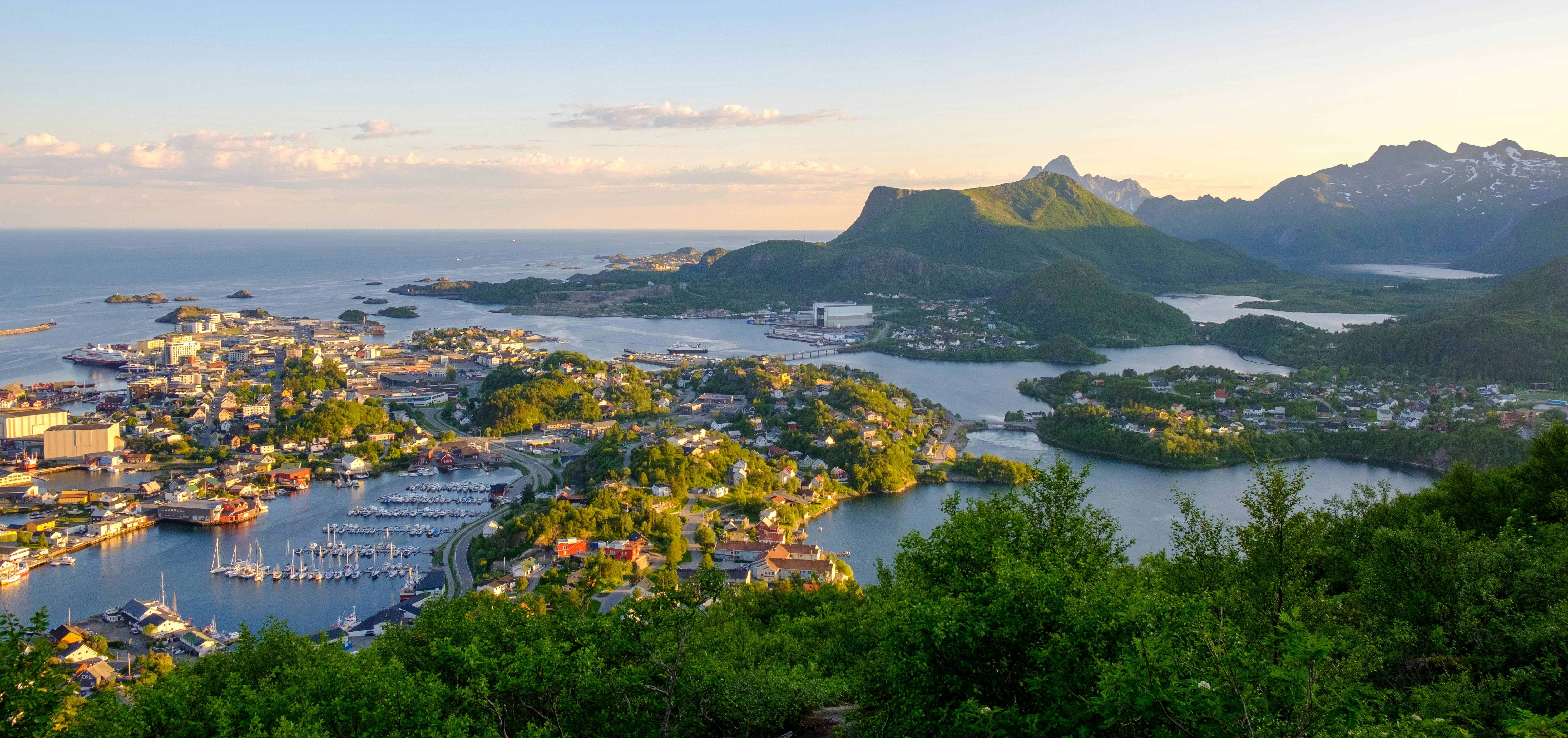 a scenic view of a Svolvaer town, harbor and mountains
