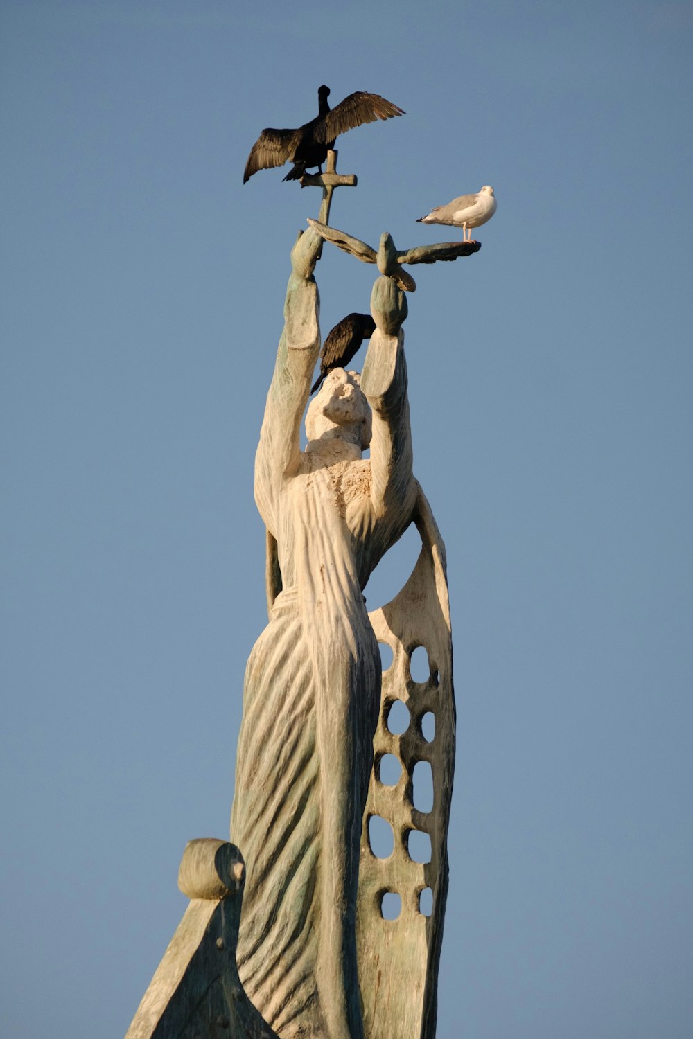 a statue of a woman holding a bird on her arm
