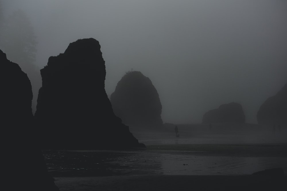 a black and white photo of some rocks in the water