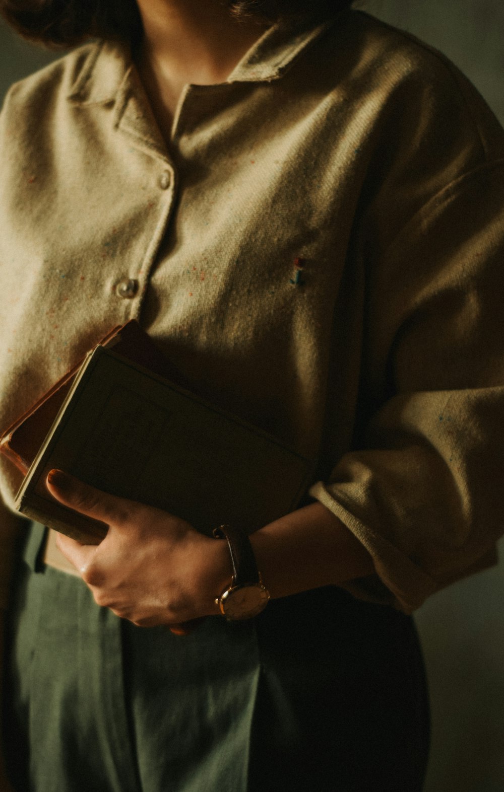 a woman holding a book in her hands