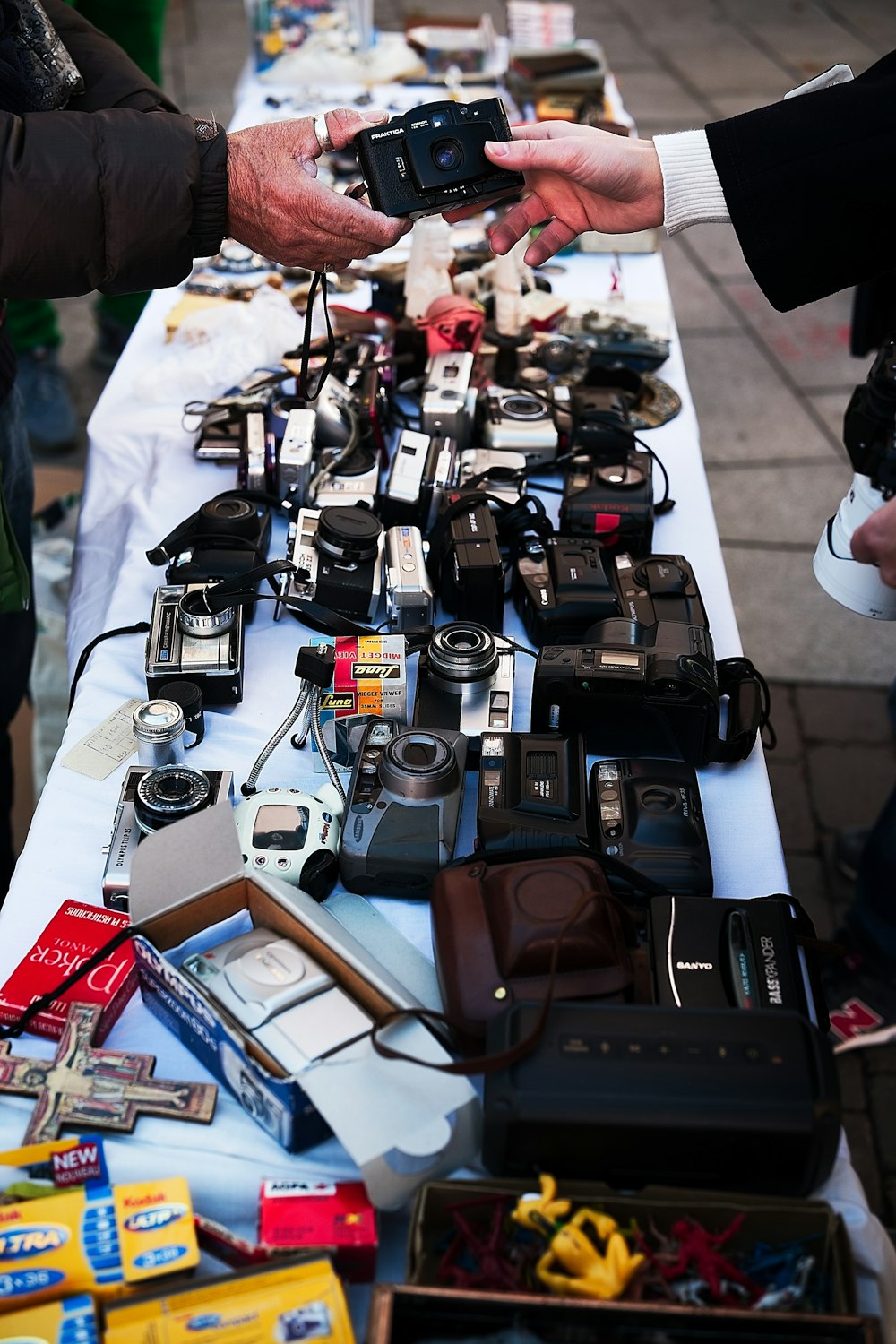 a table topped with lots of different types of cameras
