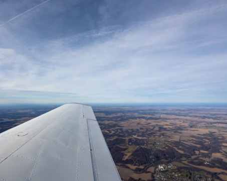 An aerial view of an aircraft flying over a landscape.