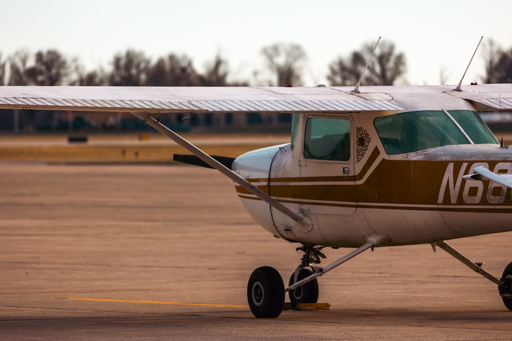 a small airplane sitting on top of an airport tarmac