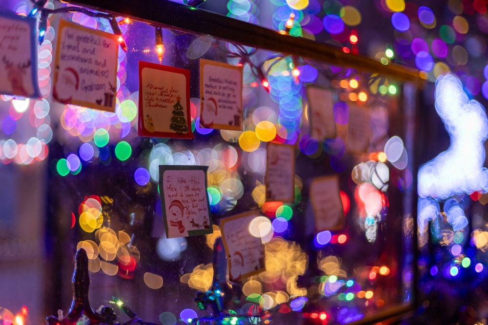 a display of christmas lights and cards on a wall