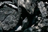 A close-up of premium charcoal and silver packaging.