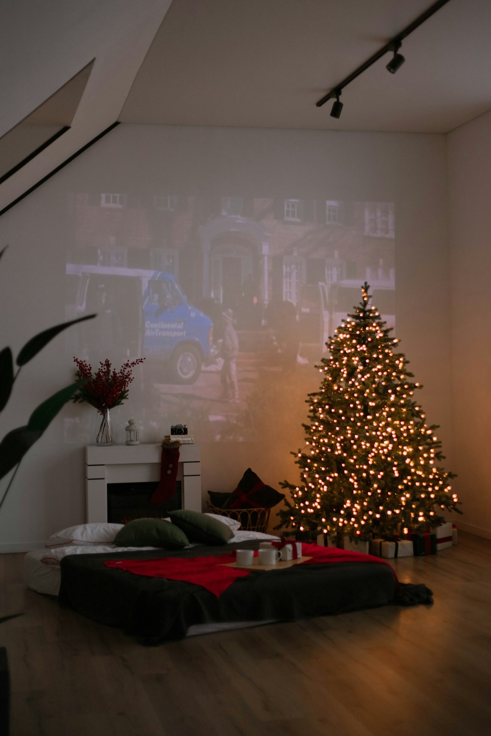 a living room with a christmas tree in the corner