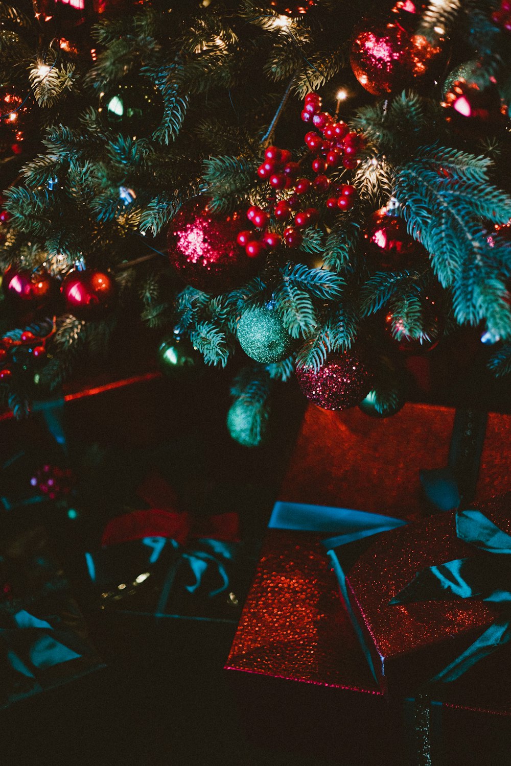 a christmas tree with presents under it