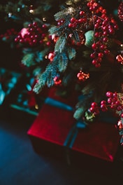 A cozy holiday scene with a beautifully wrapped Christmas gift box surrounded by festive decorations and twinkling lights.