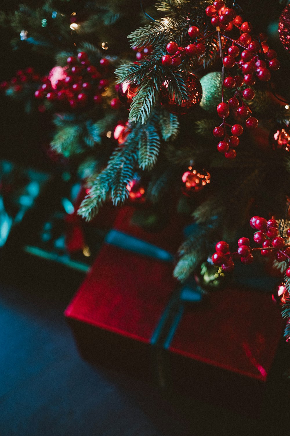 a close up of a christmas tree with presents under it