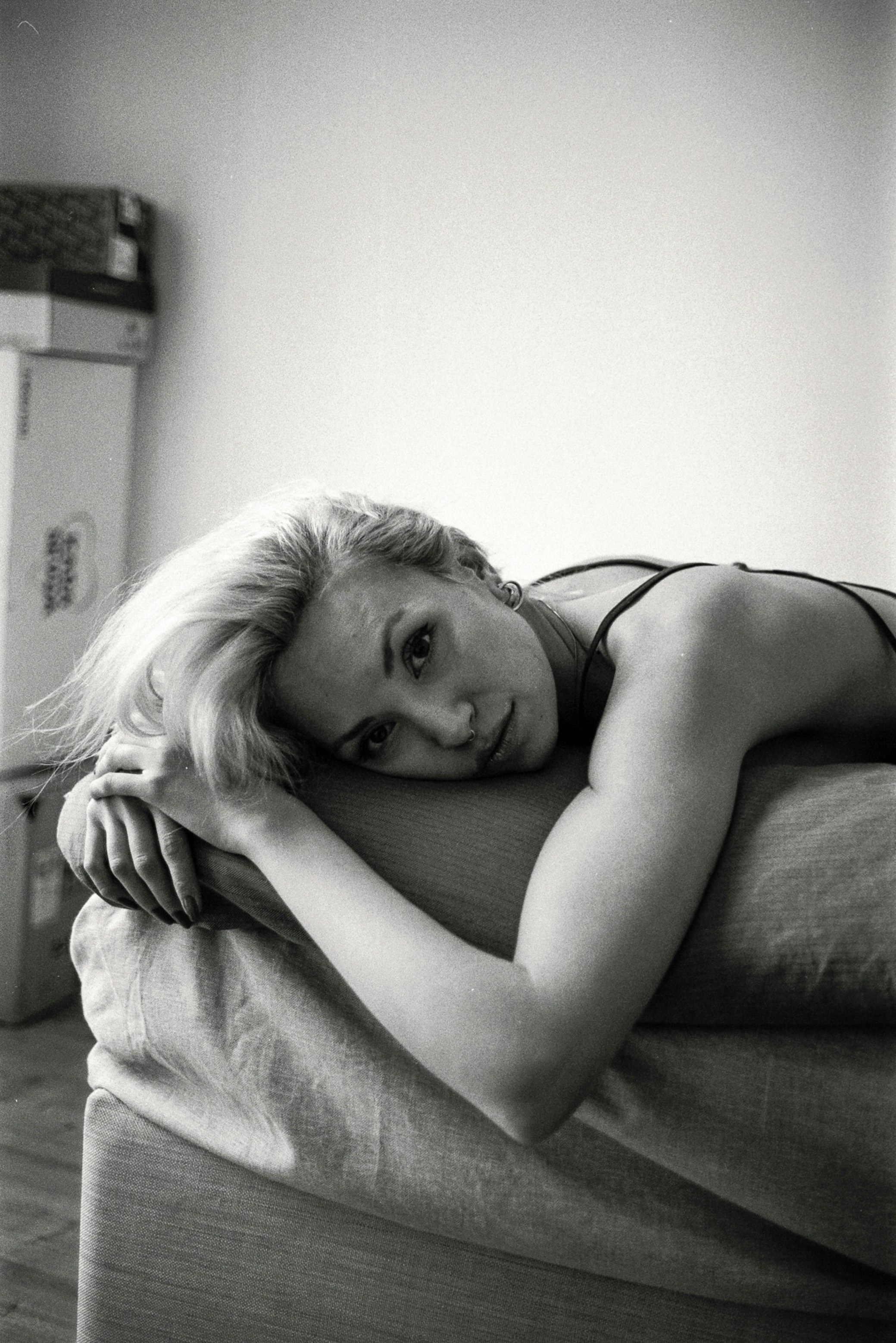 A black and white photo of a woman laying on a bed photo – Free Film ...
