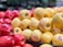 A close-up of fresh, vibrant apples stacked in a market display.