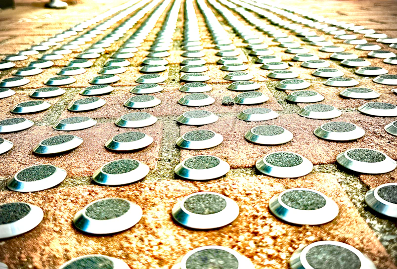 A close-up of a weathered footpath with scattered cosmic symbols etched into the pavement.