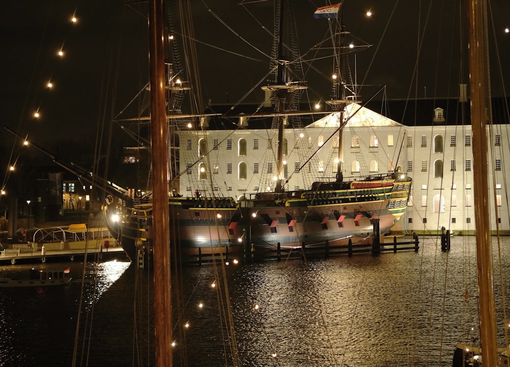 a large ship docked in a harbor at night
