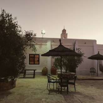 A warm family gathering in a traditional Baeza courtyard during sunset.