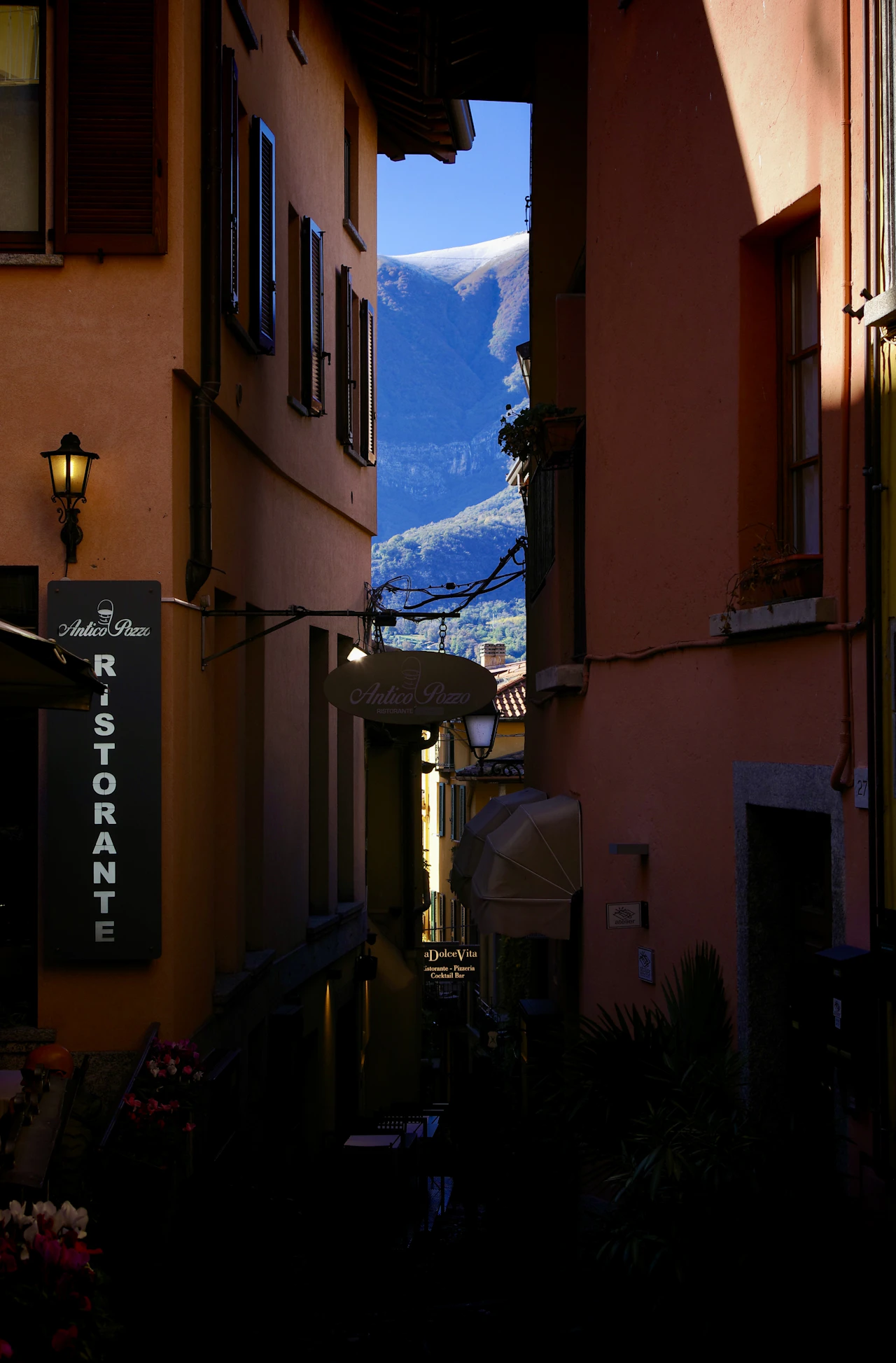A narrow alley opening onto the mountains