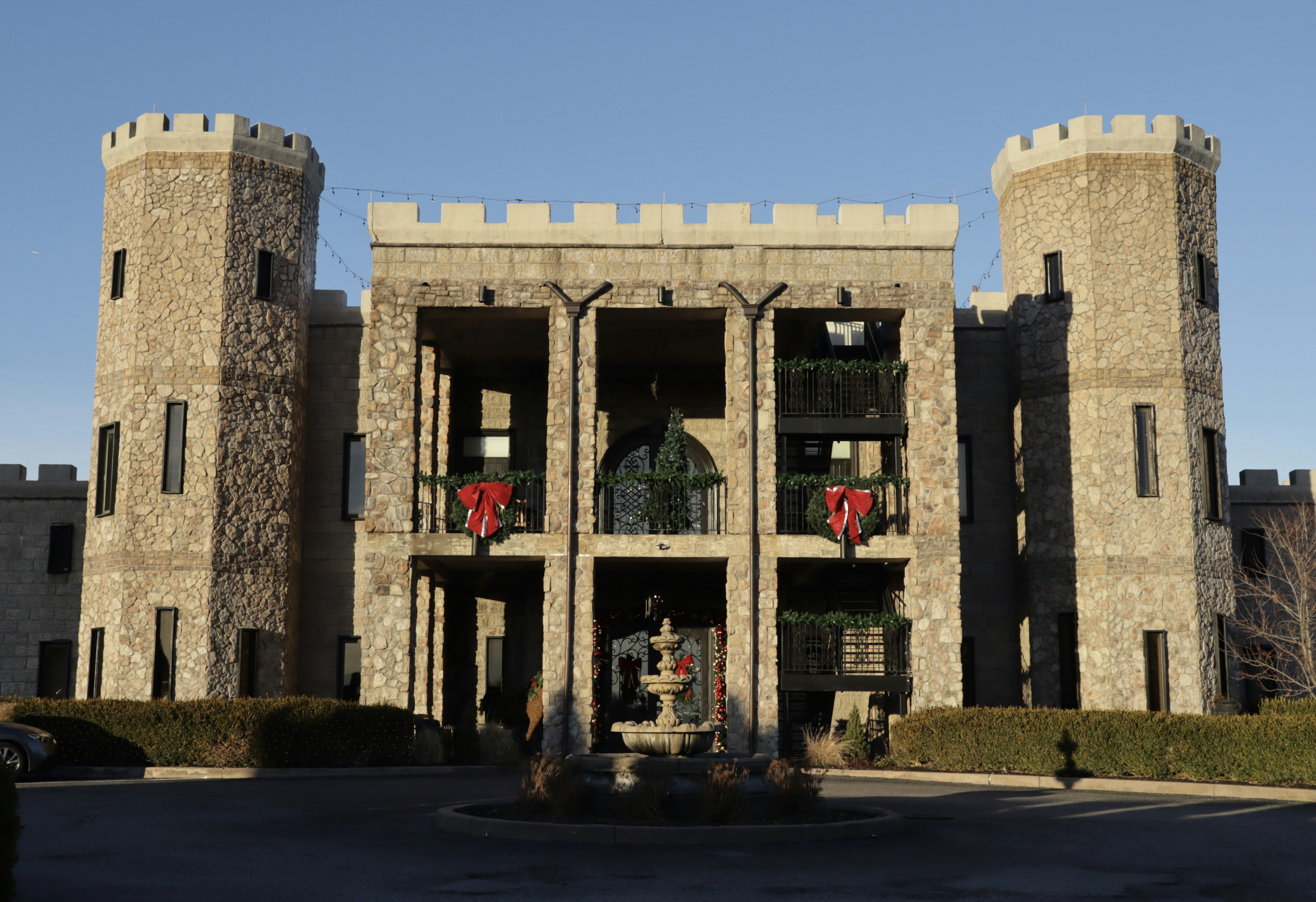 a castle like building with a fountain in front of it