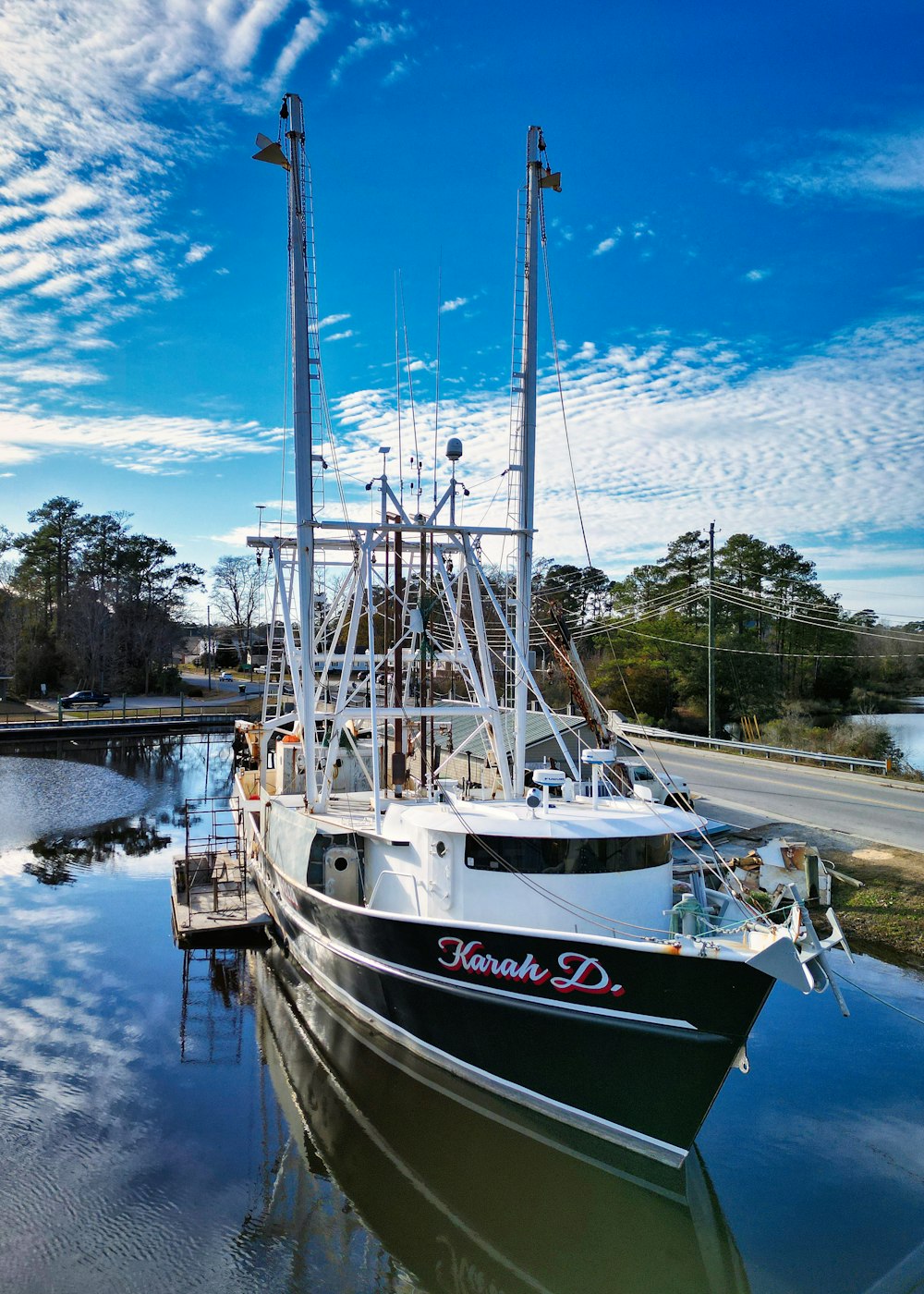 a black and white boat docked at a dock