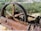 An old, rusted piece of industrial machinery with an engraved plaque showing Ingersoll-Rand Co., New York, Imperial Type 10. The machinery appears to be abandoned and situated in a natural environment with dry grass and various green shrubs.