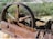 An old, rusted piece of industrial machinery with an engraved plaque showing Ingersoll-Rand Co., New York, Imperial Type 10. The machinery appears to be abandoned and situated in a natural environment with dry grass and various green shrubs.