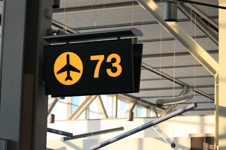 a yellow and black sign hanging from the side of a building