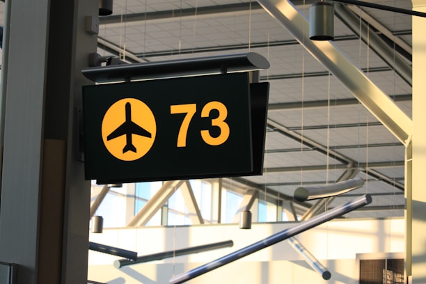 a yellow and black sign hanging from the side of a building