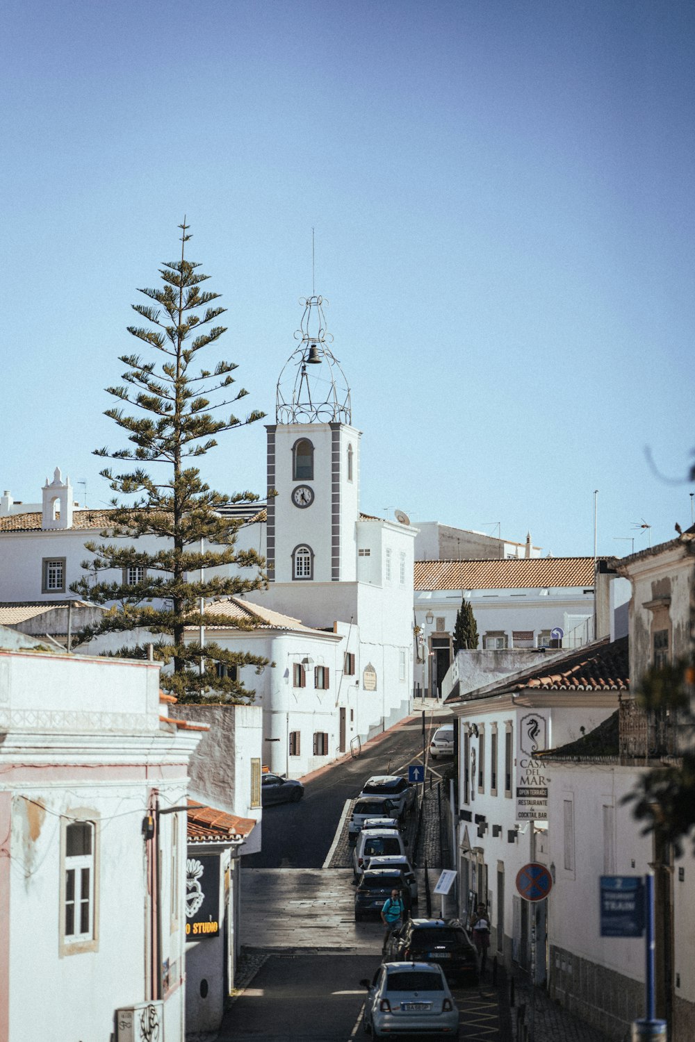 a city street with a clock tower in the background