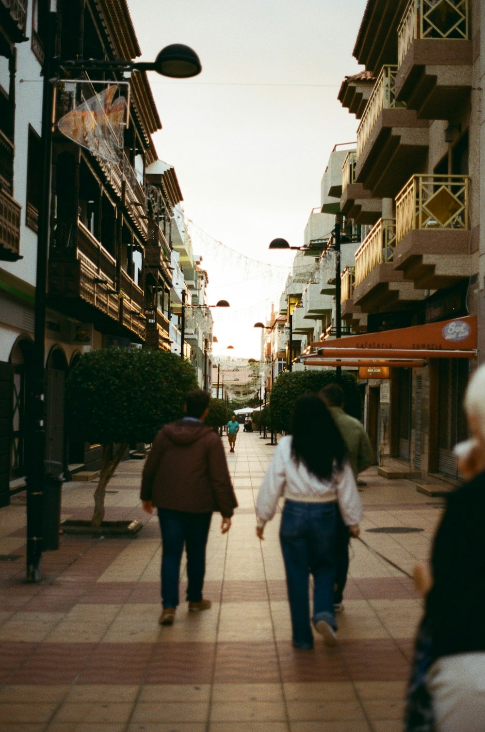 a couple of people that are walking down a street