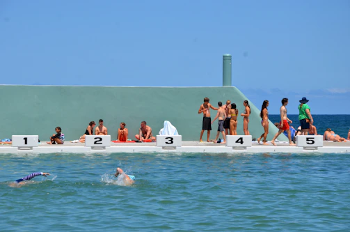 Participants sharing laughs and conversations poolside, building friendship and confidence.